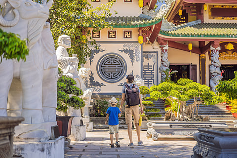 Father and son explore the Lady Buddha Temple in Da Nang, Vietnam