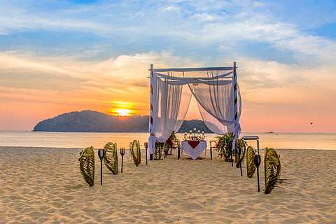 A romantic beachside setup, perfect for a wedding or sunset dinner