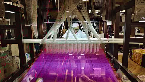 A weaver working at his loom