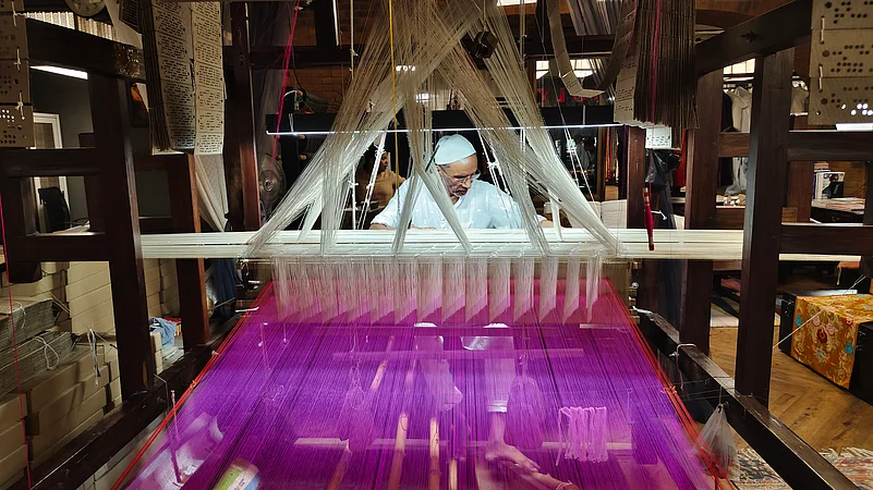A weaver working at his loom