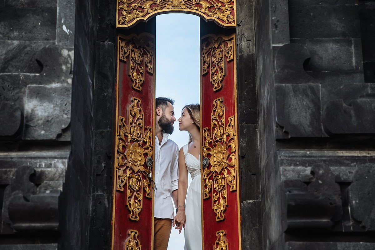 A couple shares a quiet moment outside a centuries-old temple in Bali