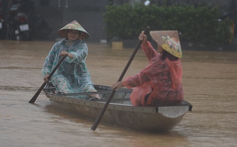 Boats being used to navigate lanes typically accessed on foot or bicycle due to the flooding.