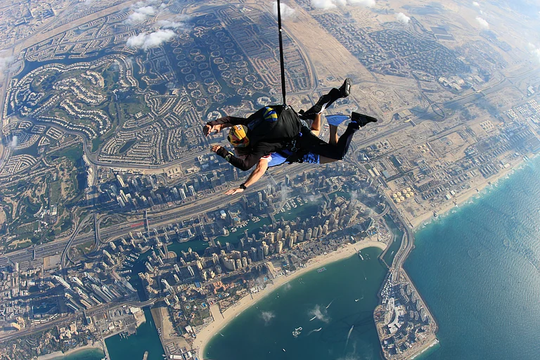 Two men skydive in tandem over the skies of Dubai - Shutterstock