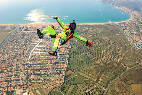 A skydiver soars over Dubai, capturing the thrill of adventure