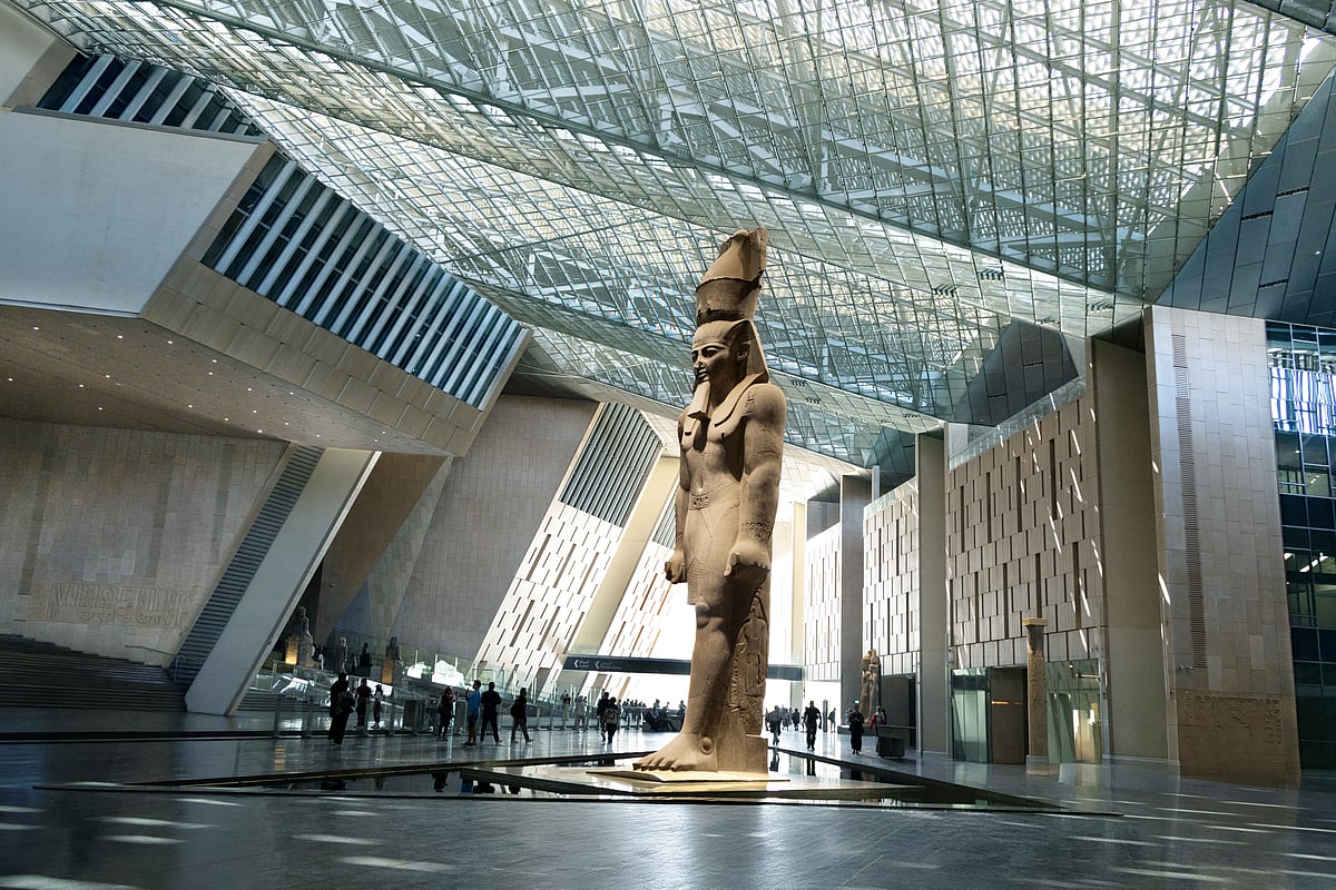 Shutterstock : Massive ancient Egyptian Ramses II﻿ statue, standing 11 meters tall under the glass skylight of the Grand Egyptian Museum