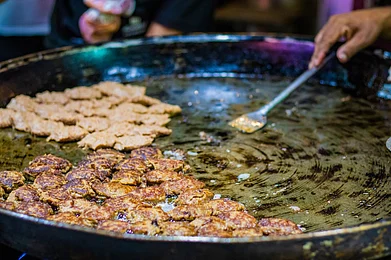 Shutterstock : Galawati being shallow-fried in Lucknow, a signature dish of traditional Mughlai cuisine known for its melt-in-the-mouth texture and aromatic spices