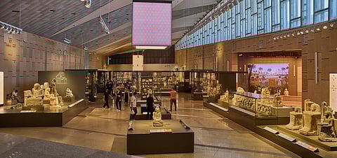 The museum's interior features a vast six-story Grand Hall flooded with natural light, showcasing monumental statues including the colossal Ramses II