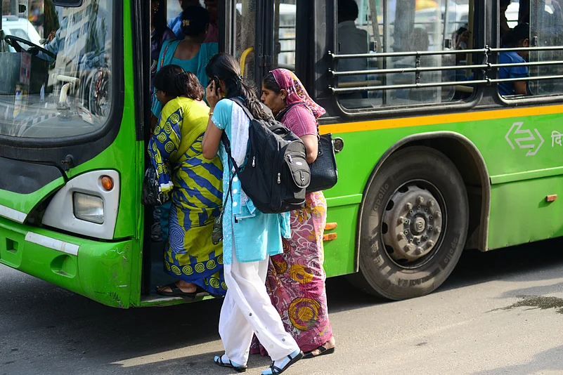 Women passengers board a DTC city bus in Delhi’s public transport network