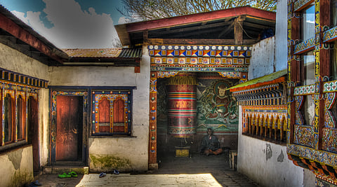 A view of Chimi Lhakhang Monastery, nestled amid fields in Lobesa, Punakha Valley