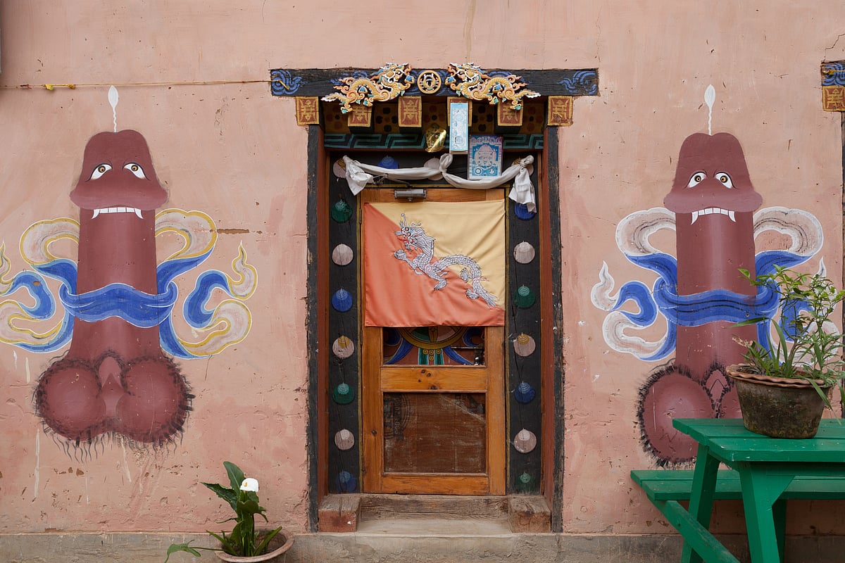 Traditional phallic paintings adorn a house near Chimi Lhakhang, symbolising protection and wisdom