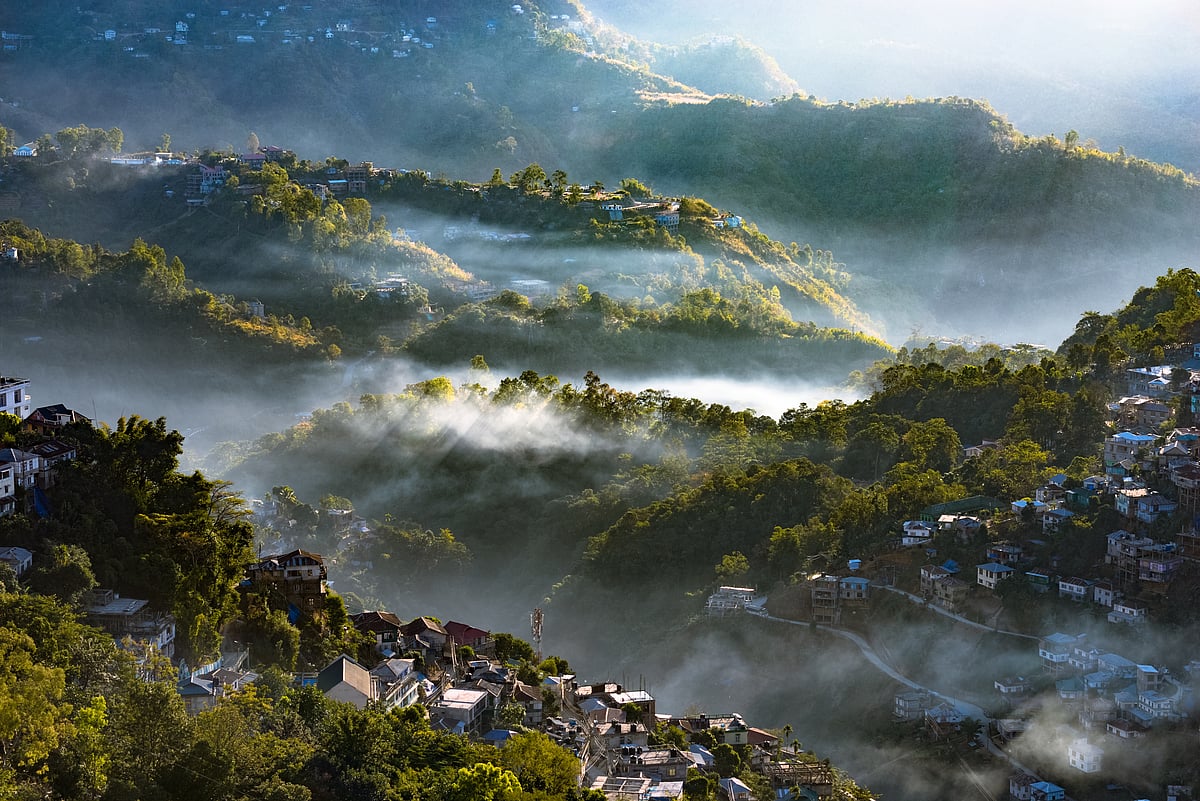 Morning sunlight breaks through clouds over the valley city of Aizawl, Mizoram