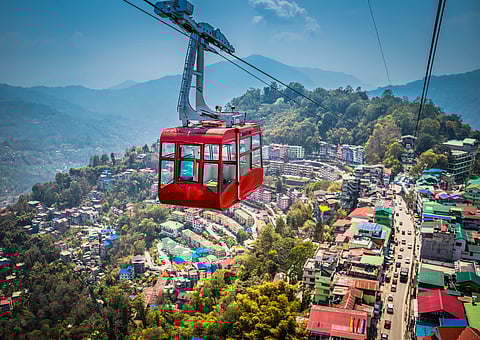 Aerial view of Gangtok with its cable car gliding over the hillside cityscape