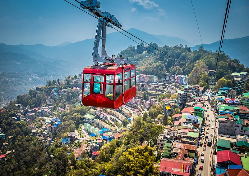 Aerial view of Gangtok with its cable car gliding over the hillside cityscape