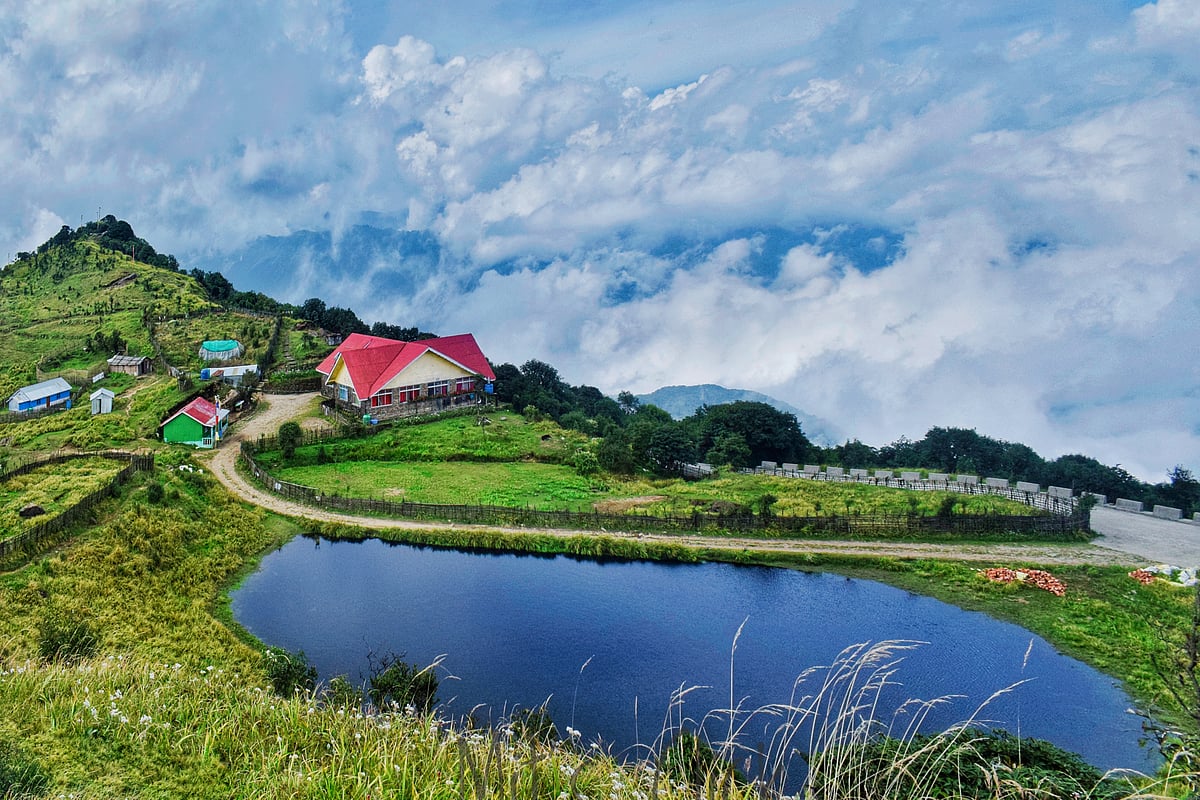 A serene hilltop village in Tonglu, Darjeeling, under a clear blue sky