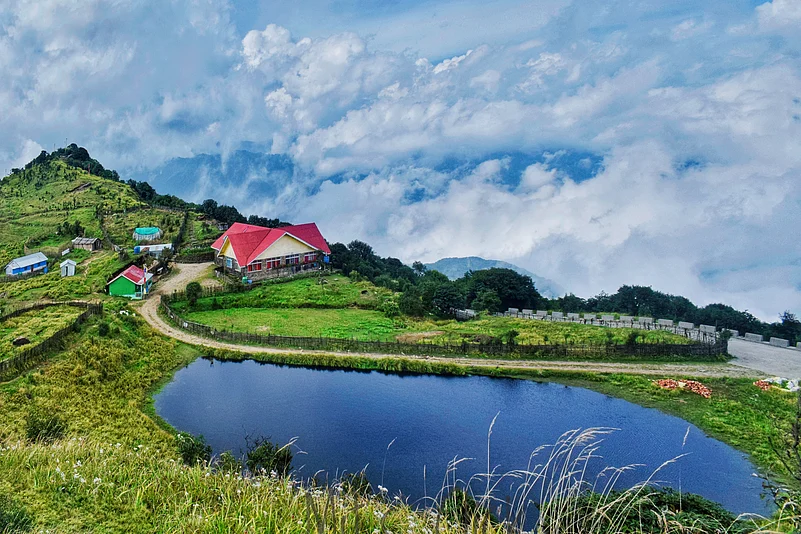 A serene hilltop village in Tonglu, Darjeeling, under a clear blue sky