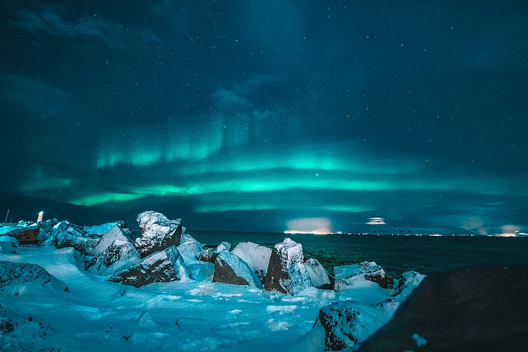 Catch breathtaking northern lights from the warmth of glass igloos or intricately carved ice suites, combining adventure with luxurious winter stays - Unsplash