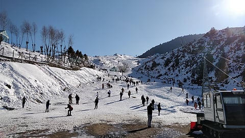 Auli’s sunlit winter slopes open to sweeping Himalayan views