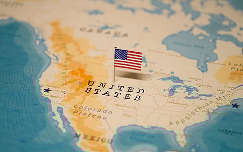 A map of the United States with the national flag