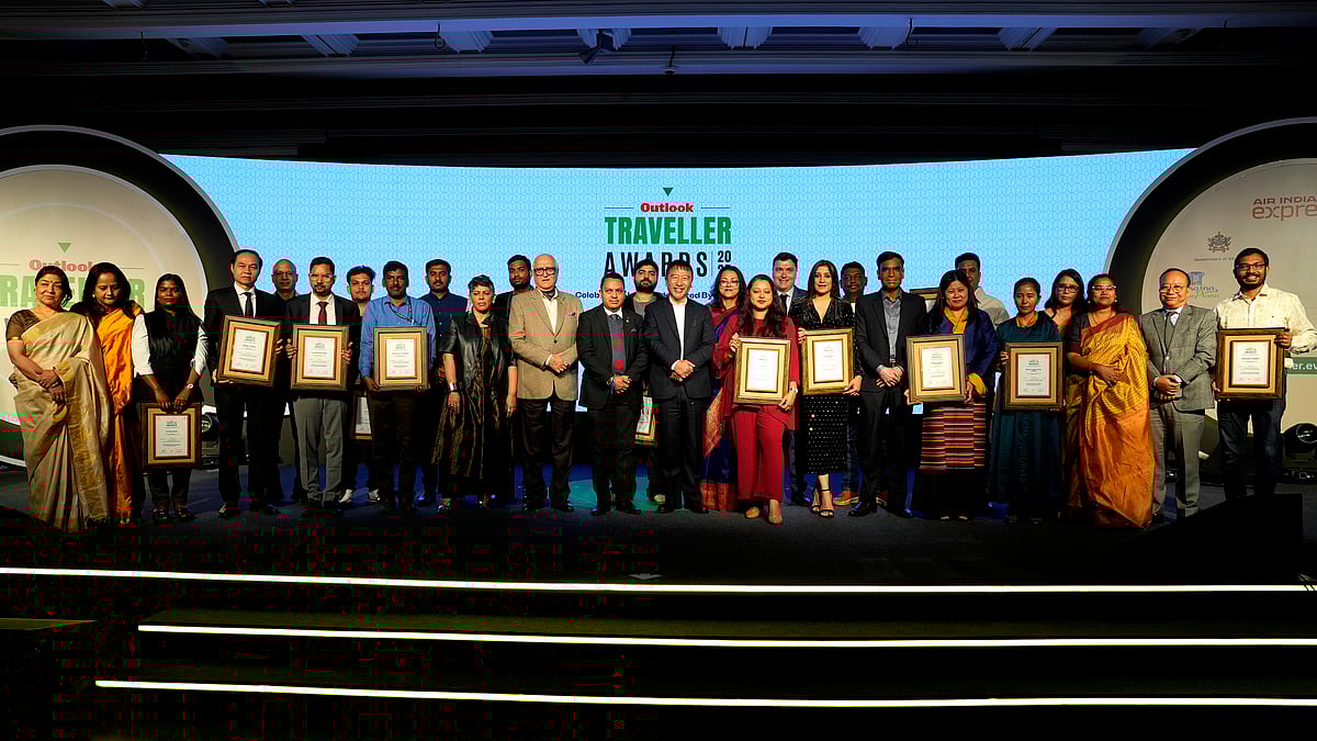 Guests and winners posing on stage at the Outlook Traveller Awards 2025 ceremony - SURESH K PANDEY