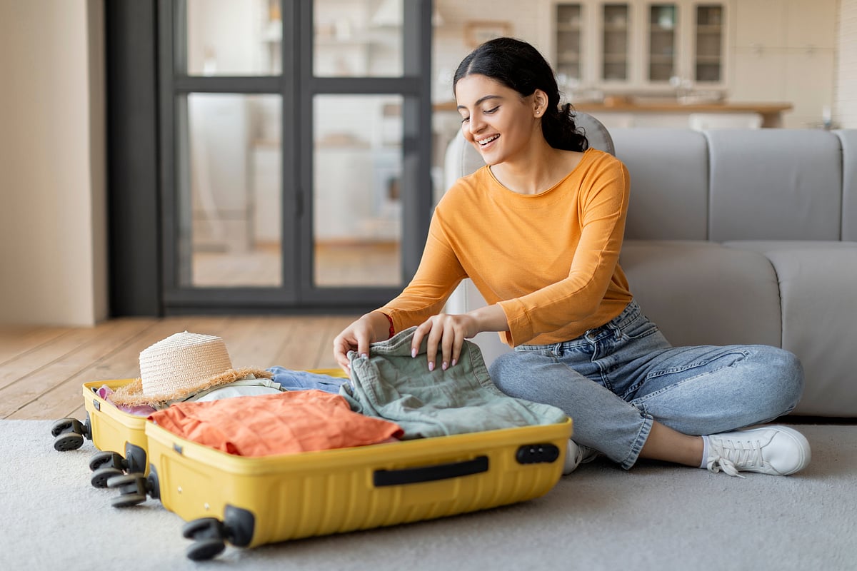 A woman packing her suitcase for a trip