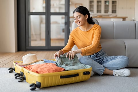 A woman packing her suitcase for a trip