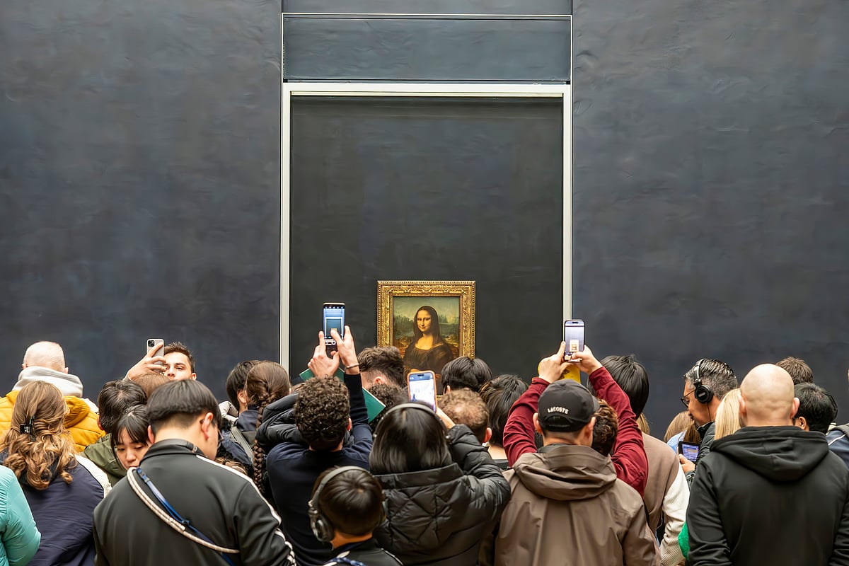 Crowds gather to photograph Leonardo da Vinci’s Mona Lisa inside the Louvre