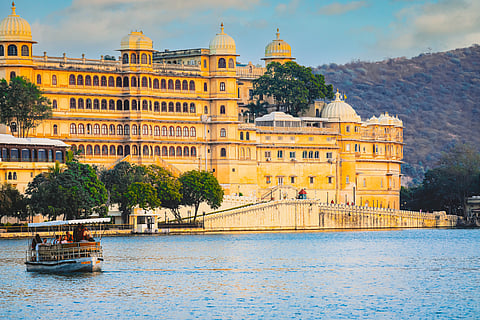 Udaipur City Palace reflected across the calm waters of Lake Pichola