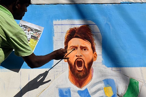 An artist paints a mural of Lionel Messi ahead of the FIFA World Cup