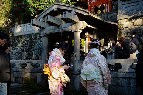 Visitors in colourful kimono gather at the Otowa Waterfall pavilion in Kiyomizu-dera, during Seijin no Hi