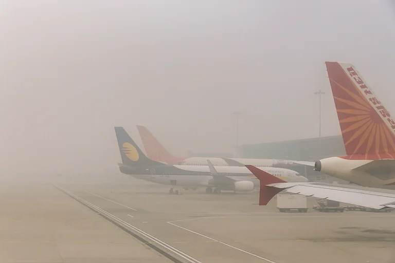 Dense fog reduces visibility at Delhi airport runway - Shutterstock