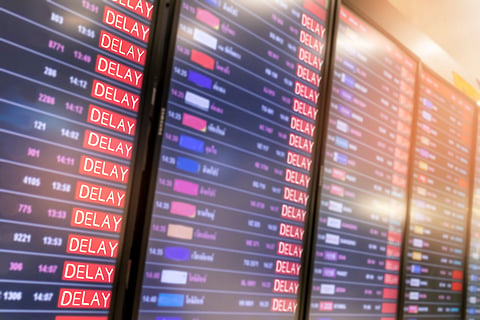 Departure board shows delays amid travel disruptions
