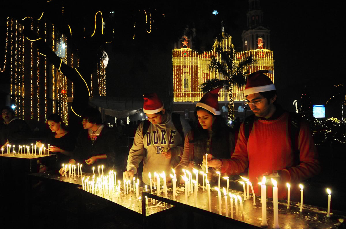 Devotees light candles and pray at the Sacred Heart Cathedral on the eve of Christmas in New Delhi - Debatosh Sengupta/Wikimedia Commons