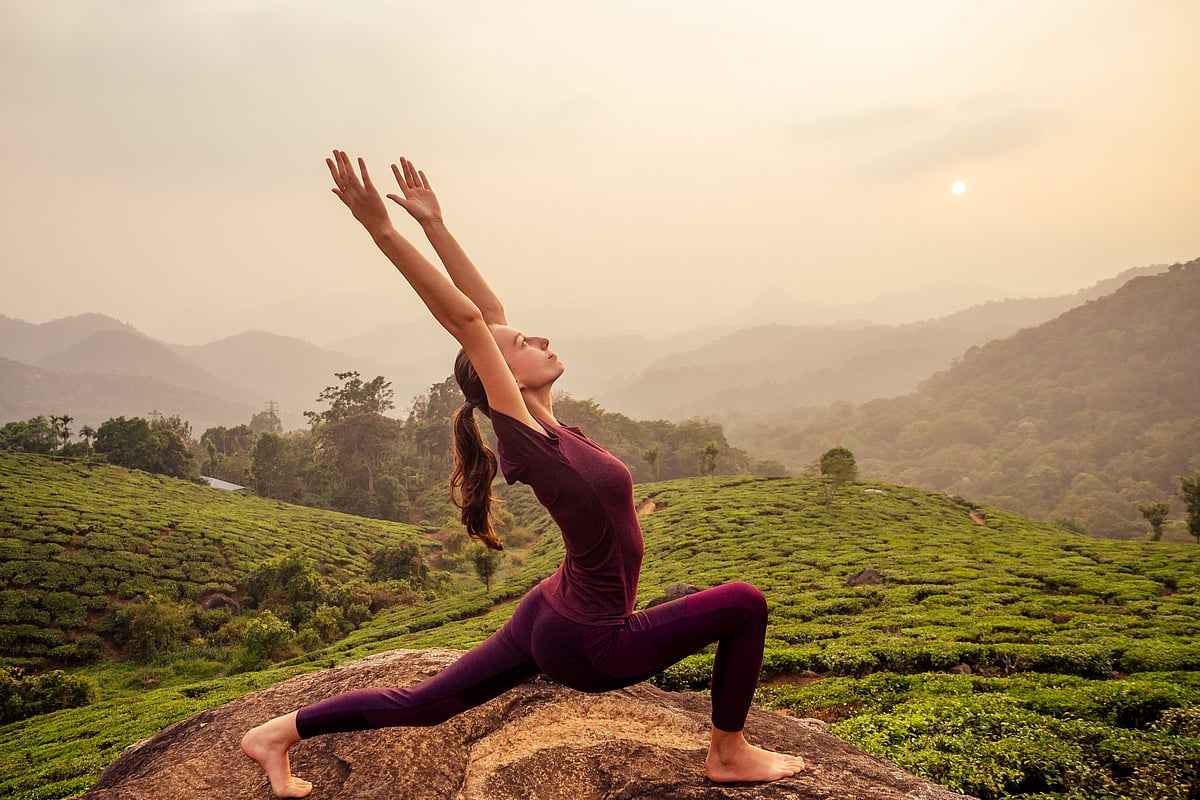 Yoga practice amid tea plantations in Munnar, Kerala