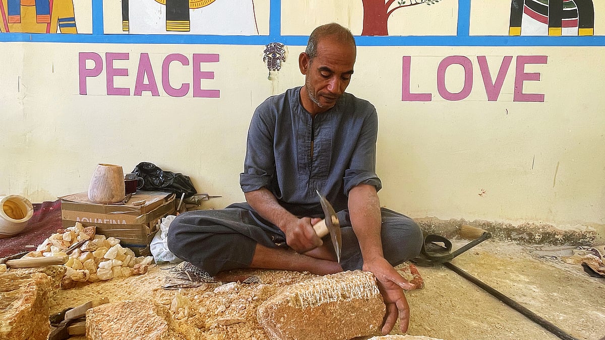 Ramadan Komsan is hammering a large calcite chunk