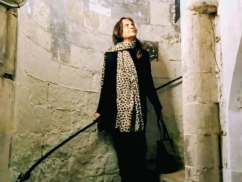 Ipsita Roy Chakraverti standing on a stone stairwell in an old London church