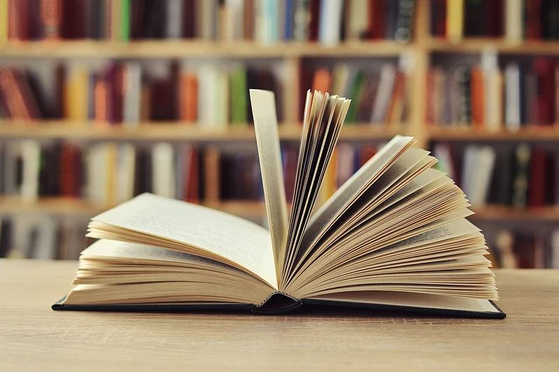An open book among shelves in a quiet reading space