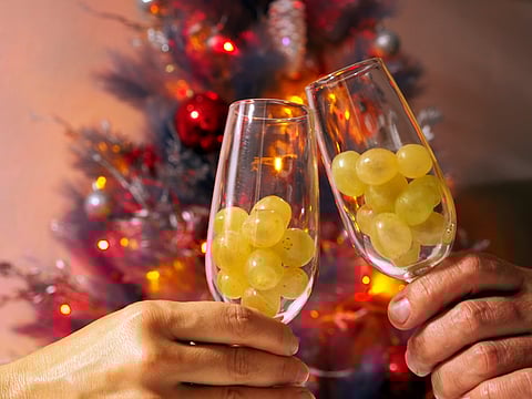 Twelve grapes in the glasses and a festive tree for the Spanish New Year tradition