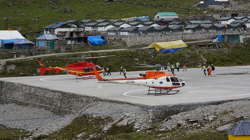 Pilgrims arrive by helicopter near Kedarnath Temple