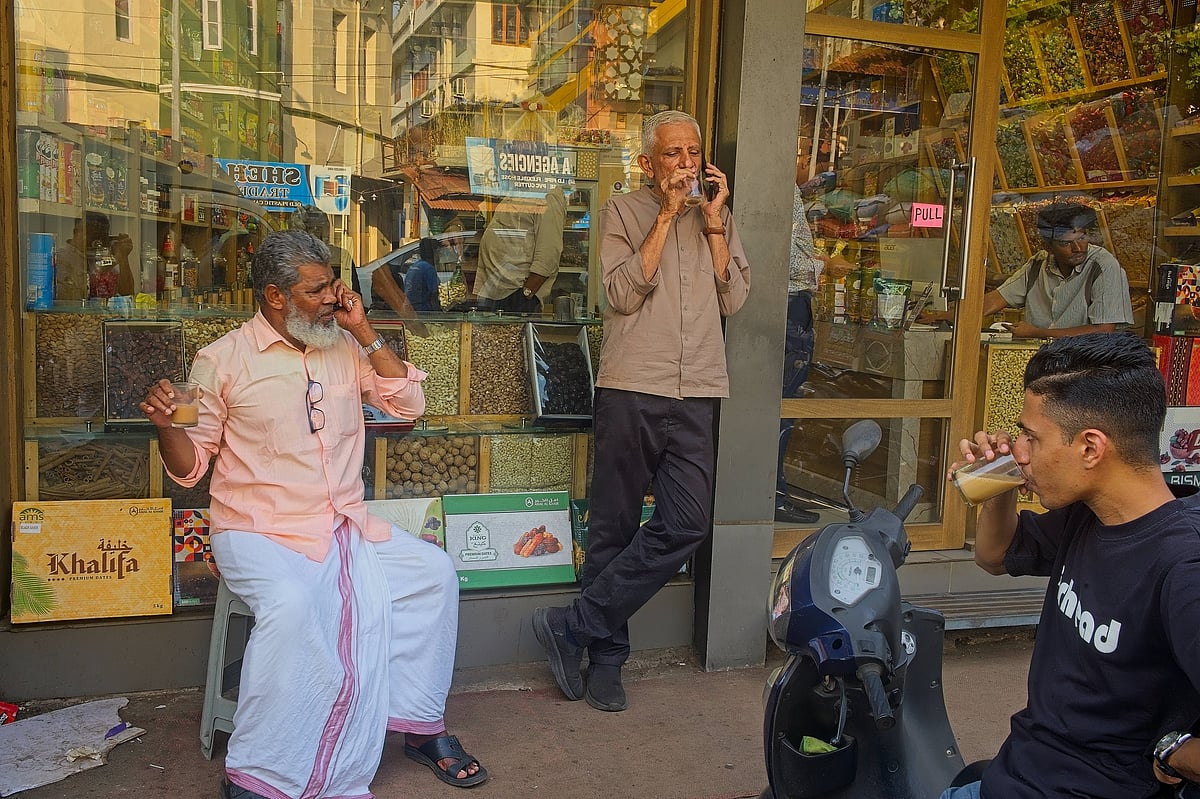 Three men drink tea