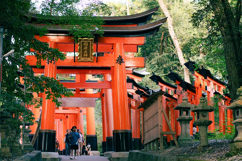 Visitors pass through the iconic torii gates at Fushimi Inari Shrine, Kyoto