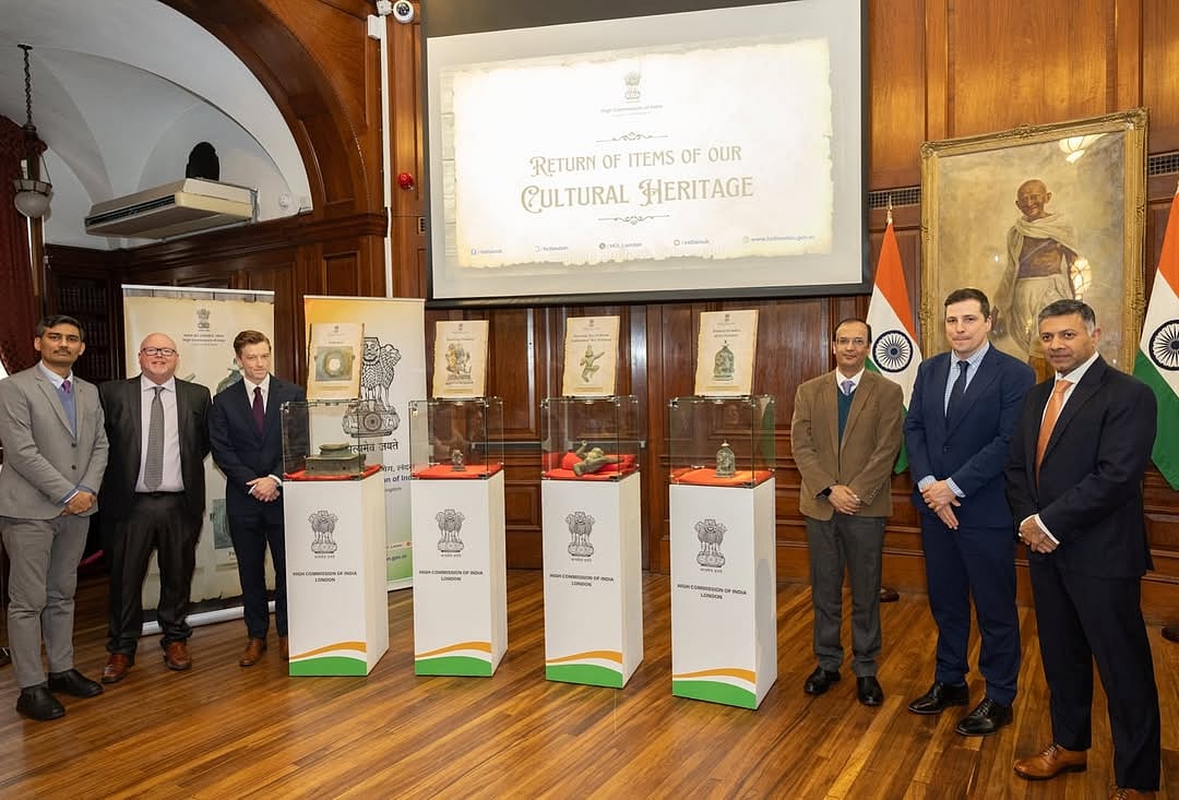 Officials pose with the artefacts at the High Commission of India, London