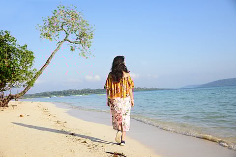 A woman walking along the beach at Havelock Island