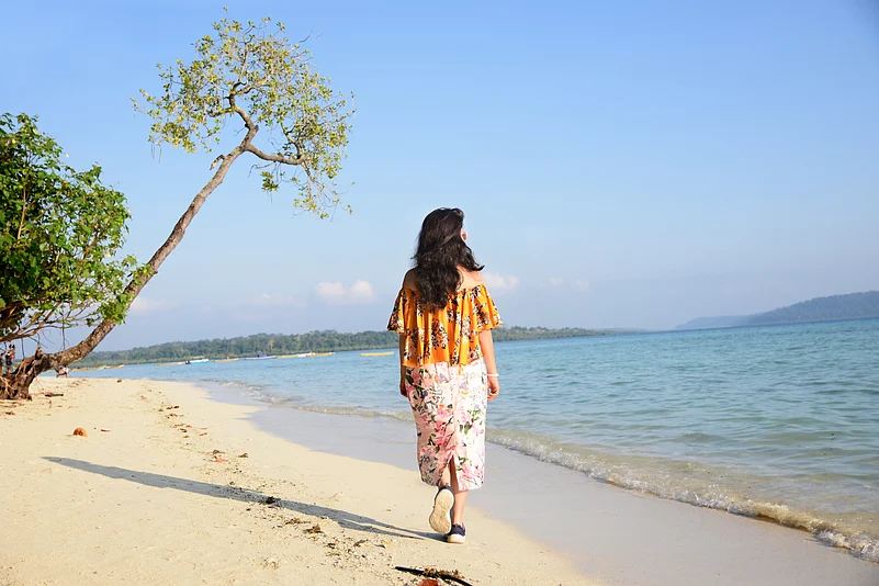 A woman walking along the beach at Havelock Island