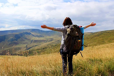 Shutterstock : A young hiker celebrating on a mountain summit