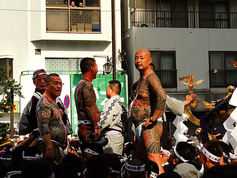 Participants display traditional tattoos during Sanja Matsuri