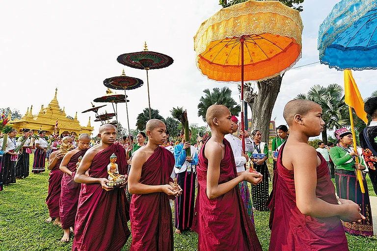 Young monks walk in procession during Sangken - Shutterstock