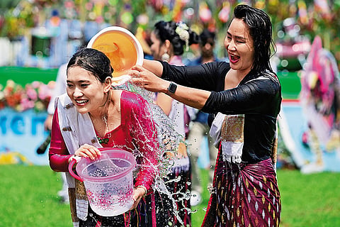 People splash water on each other during Sangken