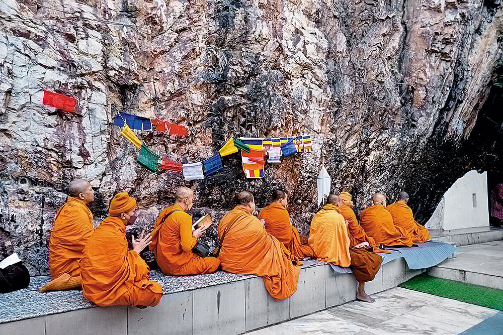 Monks gather in prayer outside Dungeshwari cave