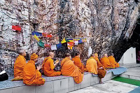 Monks gather in prayer outside Dungeshwari cave