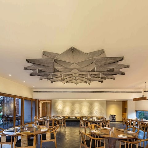 The nail and thread artwork on the ceiling of Swadesh restaurant